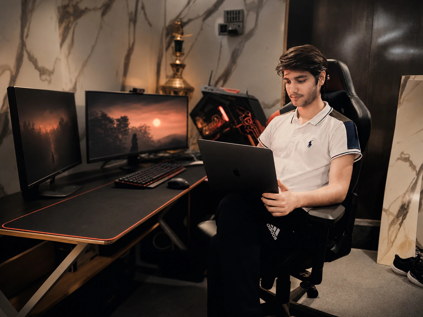 Muhammad Abdullah working on a laptop in the Lumora editing and development studio